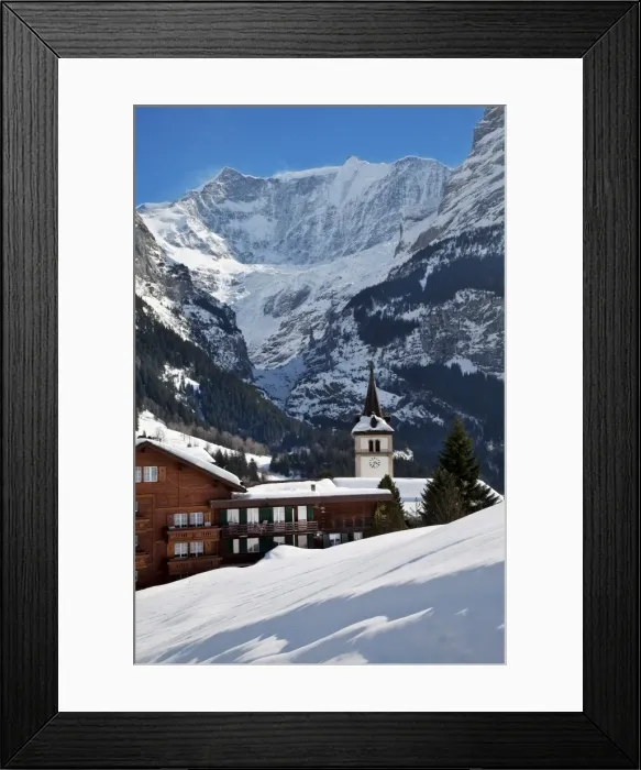 Framed Print : Snow and ice covered mountains above the village church in Grindelwald Framed Print : Snow and ice covered mountains above the village church in Grindelwald