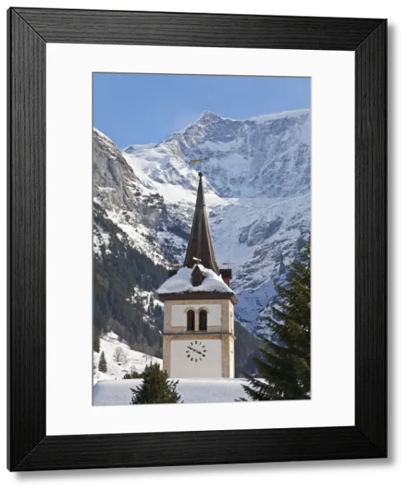Framed Print : Snow and ice covered mountains above the village church in Grindelwald Framed Print : Snow and ice covered mountains above the village church in Grindelwald