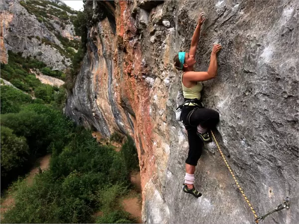 Climber makes her way up one of the rock faces of the celebrated Mascun Gorge