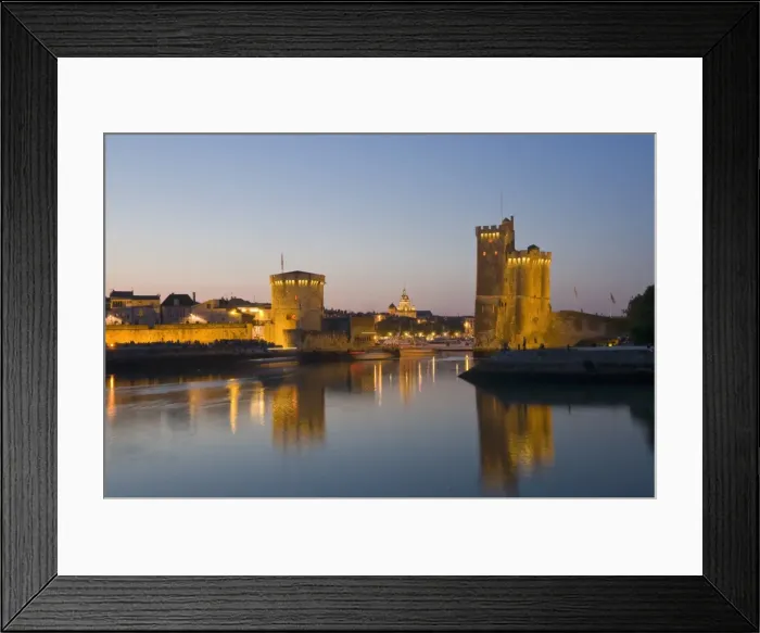 Framed Print : La Chaine and St. Nicholas towers at the entrance to the ancient port of La Rochelle at dusk Framed Print : La Chaine and St. Nicholas towers at the entrance to the ancient port of La Rochelle at dusk