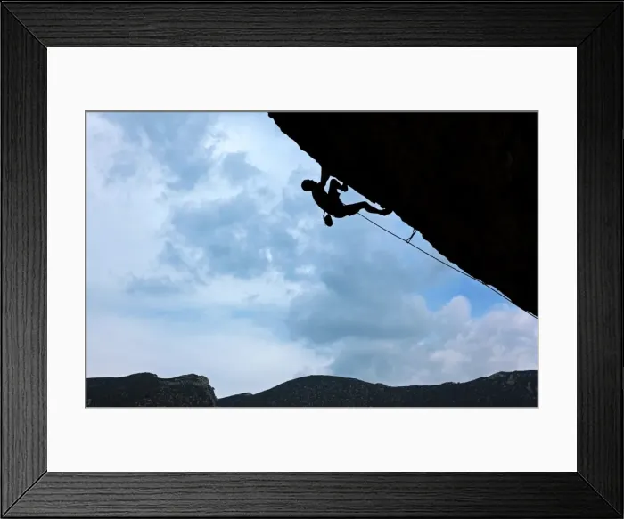 Framed Print : A climber tackles a severely overhanging route in the caves of the Mascun Gorge Framed Print : A climber tackles a severely overhanging route in the caves of the Mascun Gorge