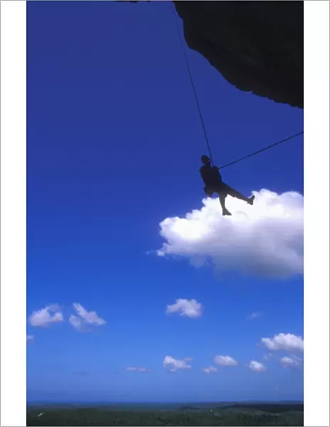 Abseiling above the jungle from the overhanging cliffs of La Costanera