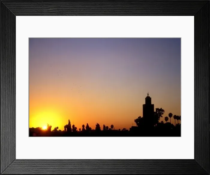 Framed Print : A flock of birds flies over the skyline of Marrakech at sunset, Morocco Framed Print : A flock of birds flies over the skyline of Marrakech at sunset, Morocco