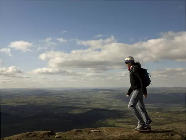 A hiker walks north from Hay Bluff, above Hay-on-Wye, Brecon Beacons National Park