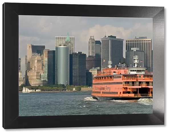 The famous orange Staten Island Ferry approaches lower Manhattan, New York