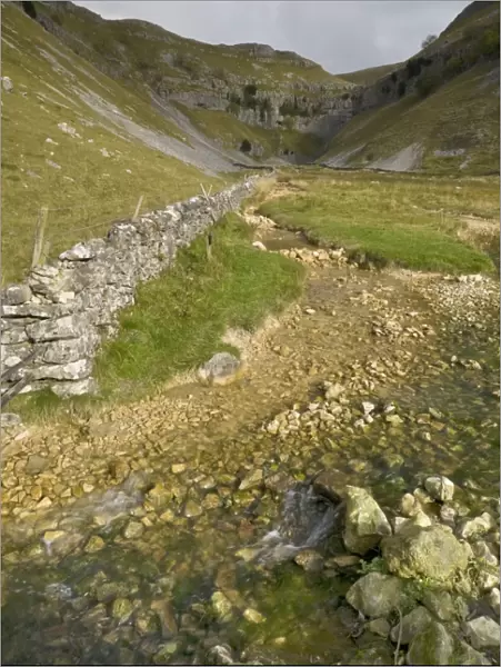 Entrance to Malham Cove with threatening clouds overhead, Yorkshire, England