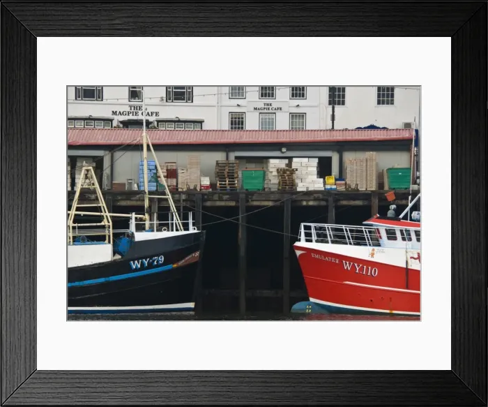 Framed Print : Fishing boats in Whitby harbour with the famous Magpie Cafe in the background Framed Print : Fishing boats in Whitby harbour with the famous Magpie Cafe in the background