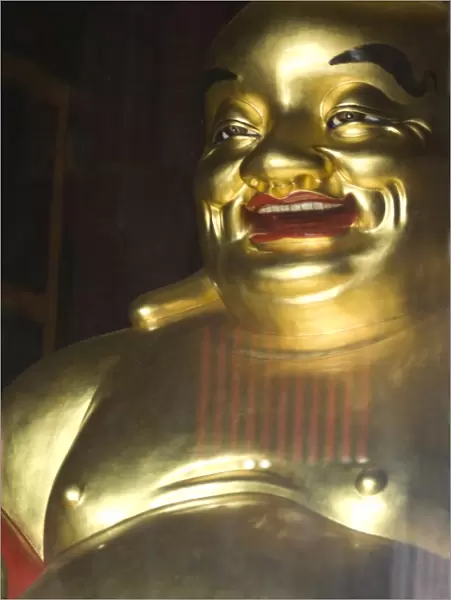 Large golden smiling Buddha in Kek Lok Si Buddhist temple, Air Itam, Georgetown
