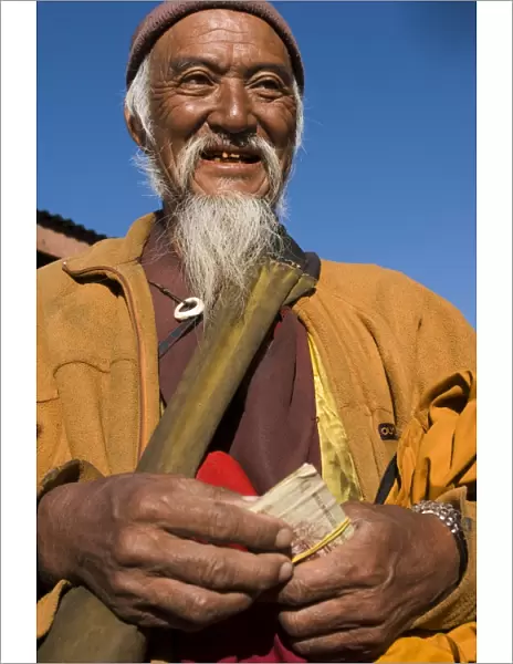 Portrait of a monk doing his morning shopping, Paro, Bhutan, Asia