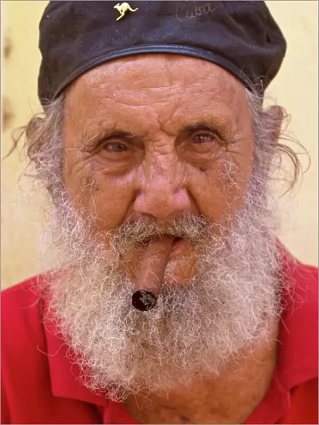 An old man with cap and white beard smoking a cigar, Havana, Cuba, West Indies