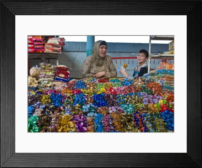 Framed Print : Woman and her son selling sweets on a market stand in the Bazaar of Osh Framed Print : Woman and her son selling sweets on a market stand in the Bazaar of Osh