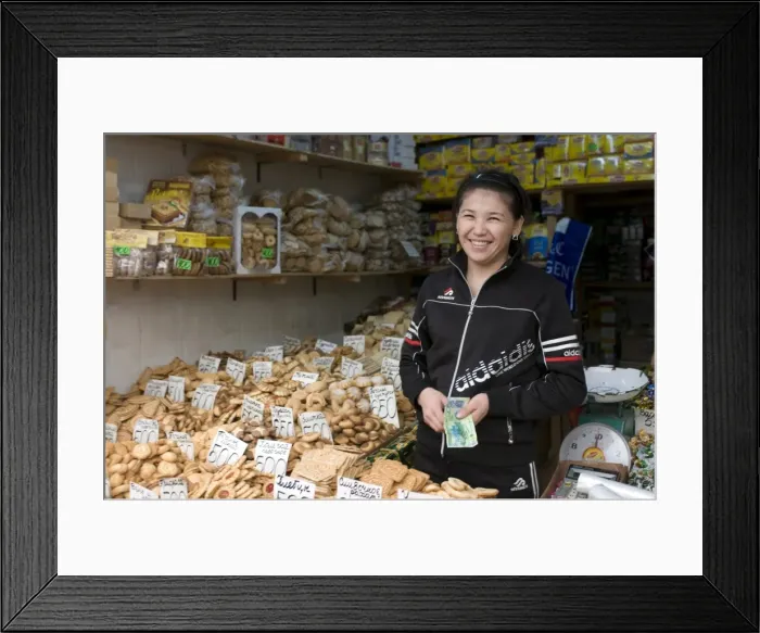 Framed Print : Friendly woman selling biscuits at a market stand, Alma Ata, Kazakhstan