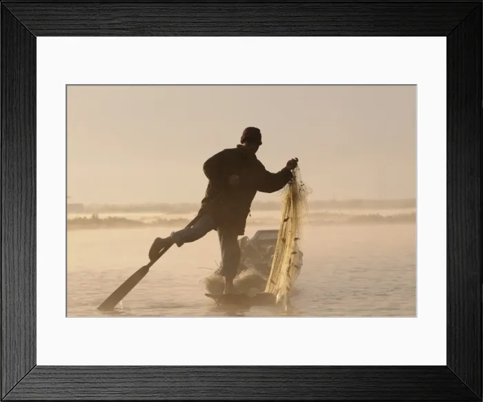 Framed Print : Fisherman holding his fishing net while rowing his little canoe, Inle lake Framed Print : Fisherman holding his fishing net while rowing his little canoe, Inle lake