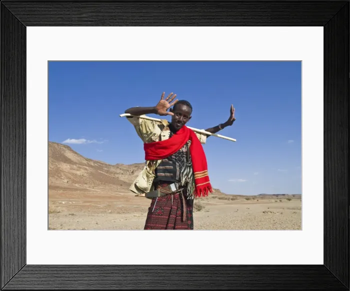 Framed Print : A young native man grinnig cheekily and holding a stick, Lac Abbe, Djibouti, Africa Framed Print : A young native man grinnig cheekily and holding a stick, Lac Abbe, Djibouti, Africa
