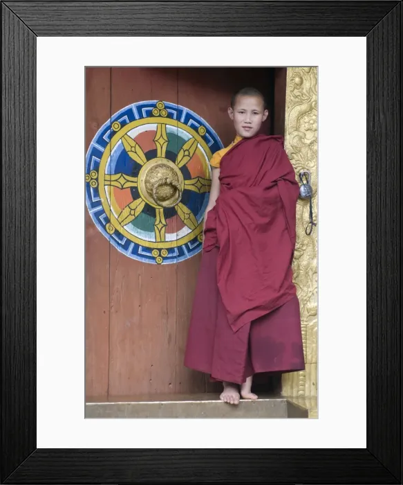 Framed Print : Young monk standing in the door of the Chimi Lhakhang monastery, Bhutan, Asia Framed Print : Young monk standing in the door of the Chimi Lhakhang monastery, Bhutan, Asia