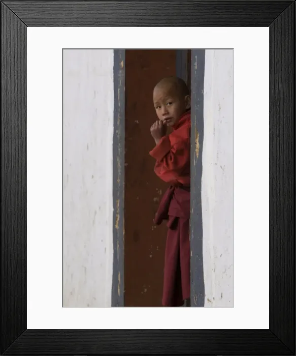 Framed Print : Little monk curiously looking around the corner in the Gangte Goempa, Bhutan, Asia Framed Print : Little monk curiously looking around the corner in the Gangte Goempa, Bhutan, Asia
