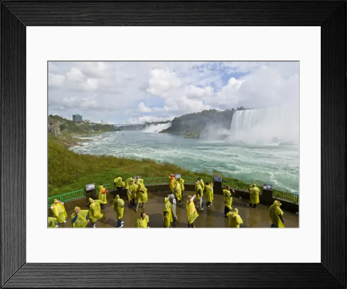 Framed Print : Many tourists in yellow raincoats in the spray of the Horseshoe Falls waterfall whilst on the Journey under the Falls tour, Niagara Falls, Ontario, Canada Framed Print : Many tourists in yellow raincoats in the spray of the Horseshoe Falls waterfall whilst on the Journey under the Falls tour, Niagara Falls, Ontario, Canada