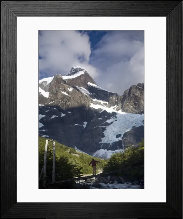 Framed Print : Woman standing on a suspension bridge over glacial fed river, Torres Del Paine National Park Framed Print : Woman standing on a suspension bridge over glacial fed river, Torres Del Paine National Park