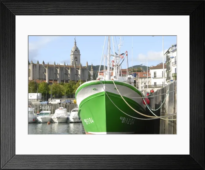 Framed Print : Old wooden fishing boat, and 15th century Gothic church of Santa Maria de la Asuncion Framed Print : Old wooden fishing boat, and 15th century Gothic church of Santa Maria de la Asuncion
