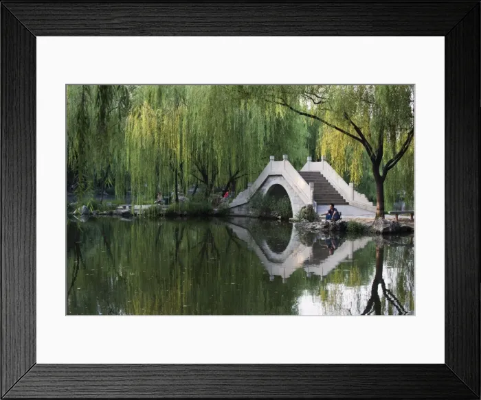 Framed Print : Man fishing next to a stone arched bridge in Zizhuyuan Black Bamboo Park Framed Print : Man fishing next to a stone arched bridge in Zizhuyuan Black Bamboo Park
