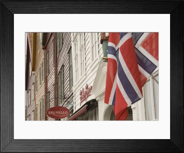 Framed Print : Wooden merchants premises and Norwegian flag, Bryggen old harbour side Framed Print : Wooden merchants premises and Norwegian flag, Bryggen old harbour side