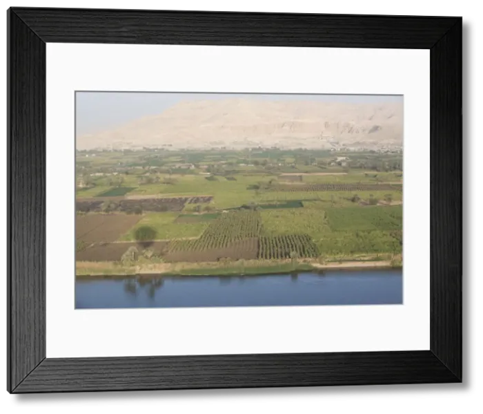 Framed Print : View of the side of the River Nile with the Temple of Deir El Bahari in the background Framed Print : View of the side of the River Nile with the Temple of Deir El Bahari in the background
