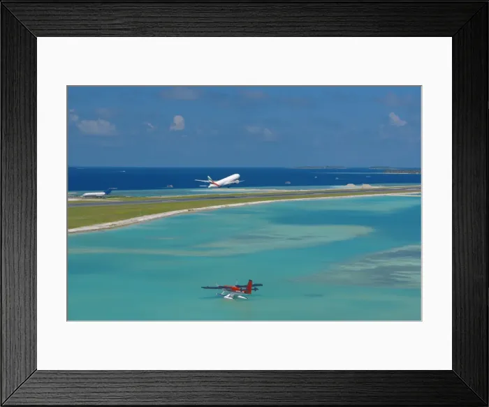 Framed Print : Passenger jet taking off from Male International Airport, and Maldivian air taxi ready to take off Framed Print : Passenger jet taking off from Male International Airport, and Maldivian air taxi ready to take off
