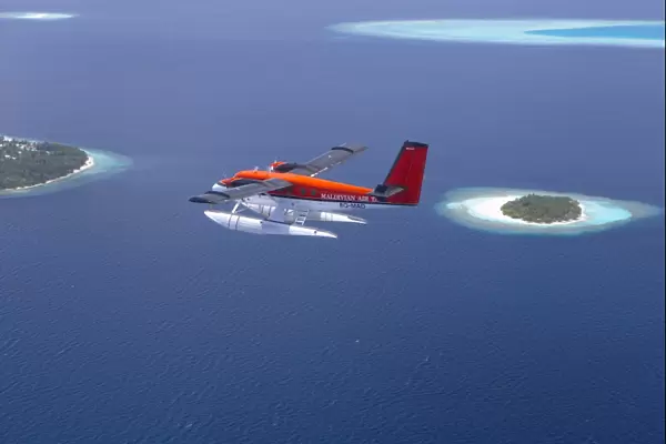 Aerial view of Maldivian air taxi flying above islands in the Maldives