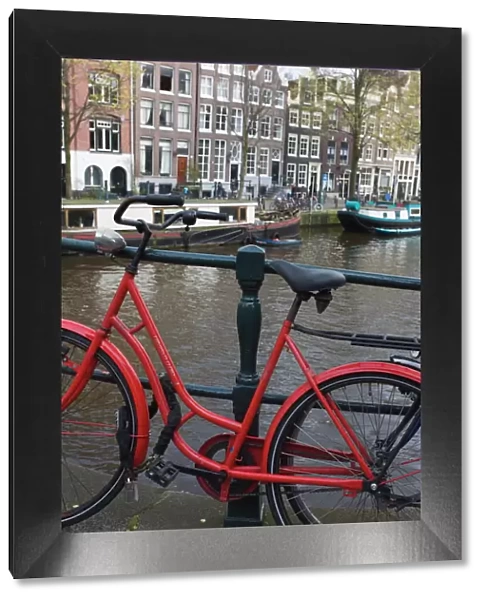 Red bicycle by the Herengracht canal, Amsterdam, Netherlands, Europe