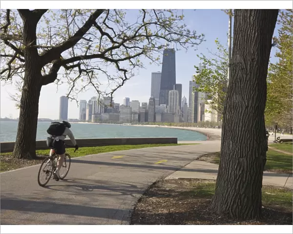 Cyclist by Lake Michigan shore, Gold Coast district, Chicago, Illinois