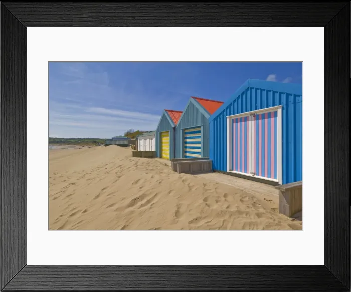 Framed Print : Multicoloured beach huts in the dunes on the long sweeping Morfa Gors beach