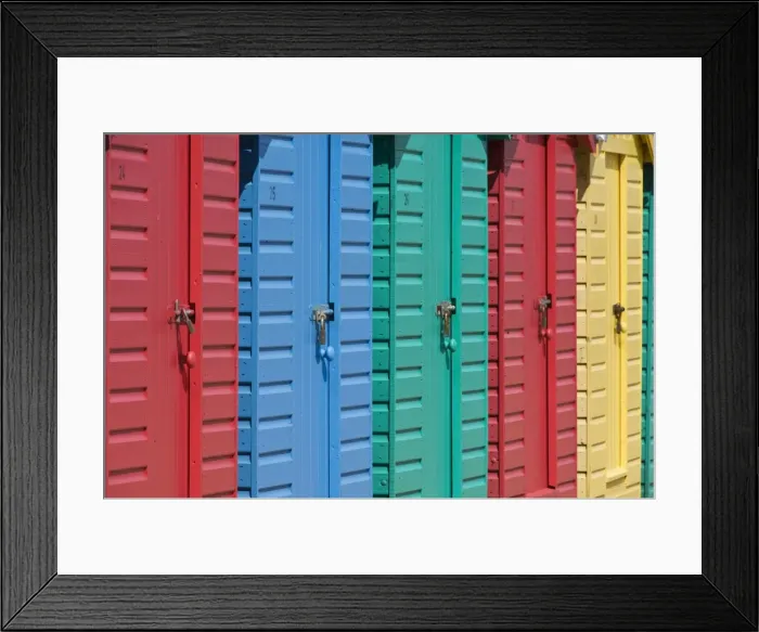Framed Print : Close-up of multicoloured beach huts on the long sweeping beach of Llanbedrog Framed Print : Close-up of multicoloured beach huts on the long sweeping beach of Llanbedrog