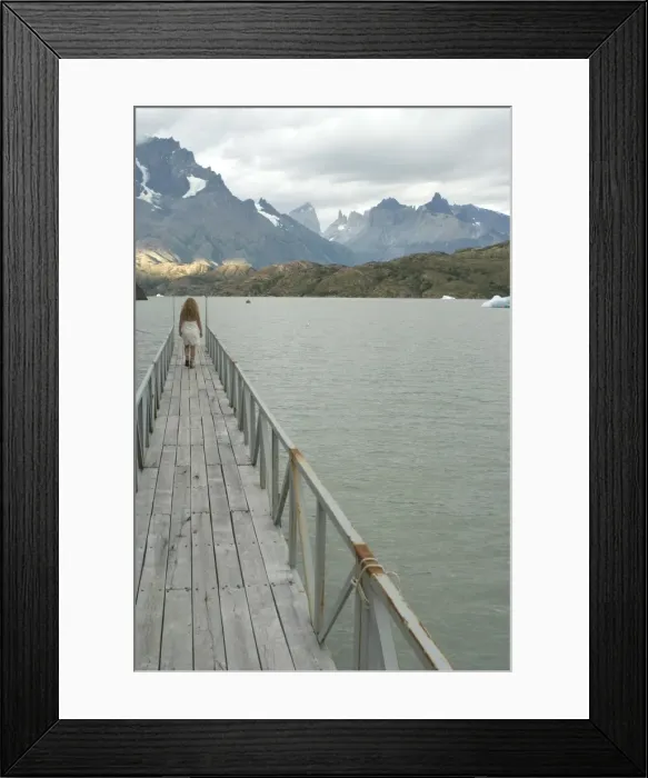 Framed Print : Blonde woman walks to the end of dock on Lago Grey, Torres del Paine, Chile Framed Print : Blonde woman walks to the end of dock on Lago Grey, Torres del Paine, Chile