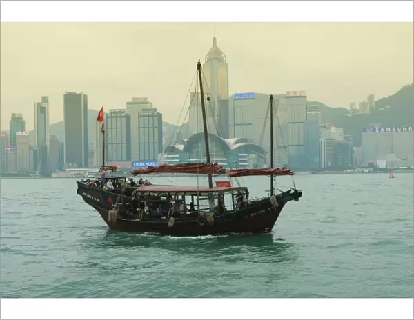 One of the last remaining Chinese junk boats sails on Victoria Harbour