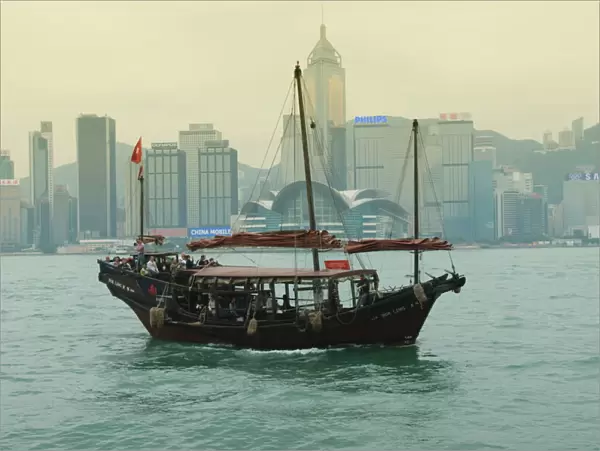 One of the last remaining Chinese junk boats sails on Victoria Harbour