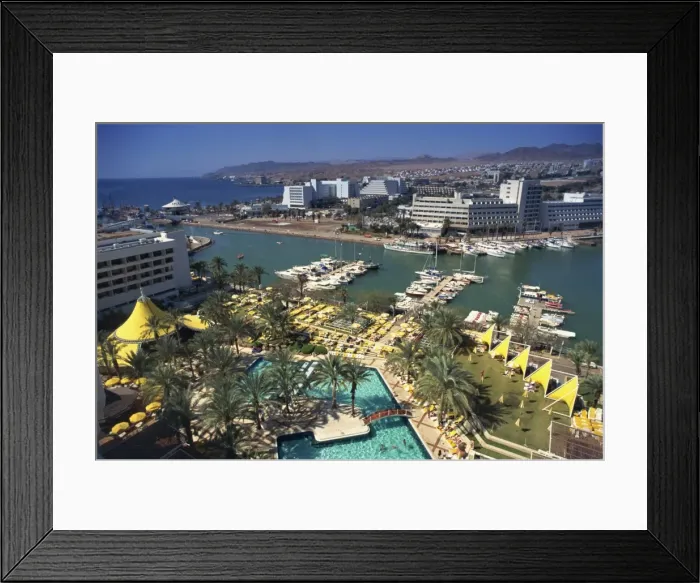 Framed Print : Aerial view over swimming pool, palm trees and the marina at Eilat, with modern buildings in the background, Israel Framed Print : Aerial view over swimming pool, palm trees and the marina at Eilat, with modern buildings in the background, Israel