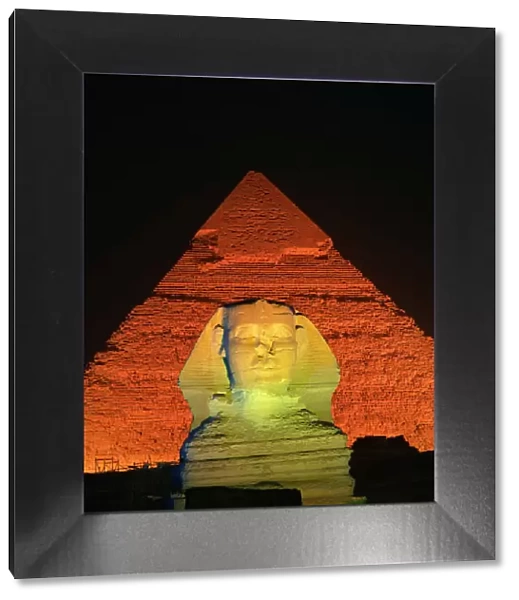 The Sphinx and one of the pyramids illuminated at night, Giza, UNESCO World Heritage Site