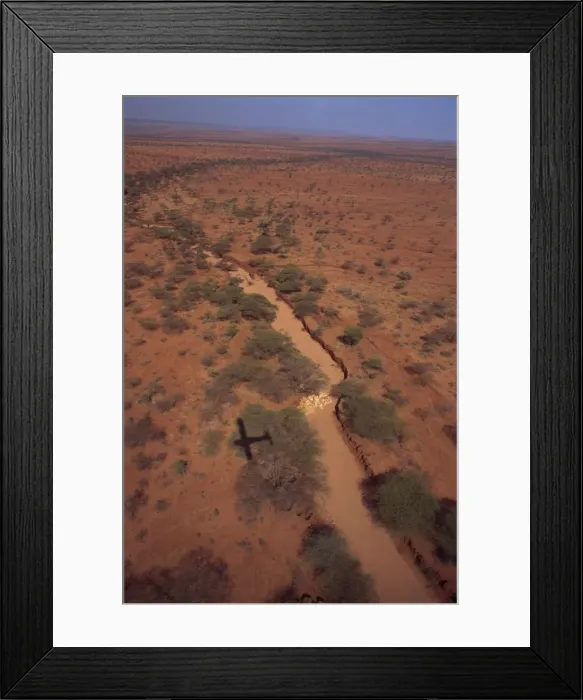 Framed Print : Plane flying over sand river or lugga which may only flow with water a few days each year Framed Print : Plane flying over sand river or lugga which may only flow with water a few days each year