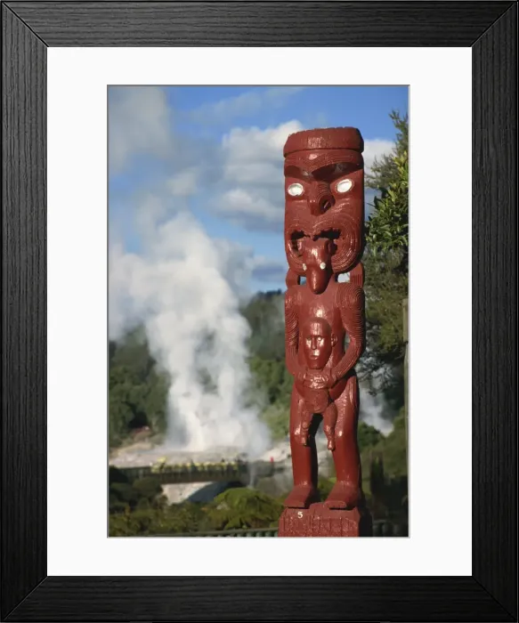 Framed Print : Traditional Maori carving and Pohutu geyser, Whakarewarewa, Rotorua, North Island Framed Print : Traditional Maori carving and Pohutu geyser, Whakarewarewa, Rotorua, North Island