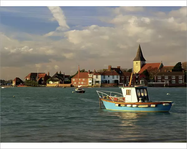 View across water at high tide, Bosham village and harbour, Sussex, England