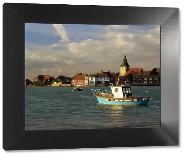 View across water at high tide, Bosham village and harbour, Sussex, England