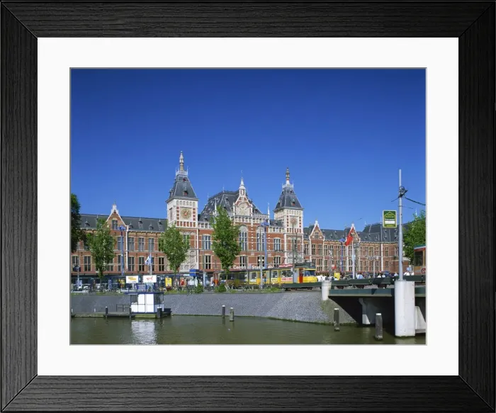 Framed Print : The Canal and tram in front of the Central Station in Amsterdam, Holland, Europe Framed Print : The Canal and tram in front of the Central Station in Amsterdam, Holland, Europe