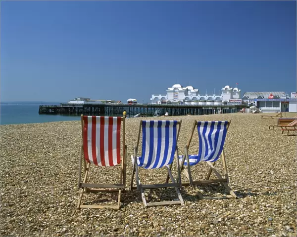 Empty deck chairs on the beach and the Southsea Pier, Southsea, Hampshire