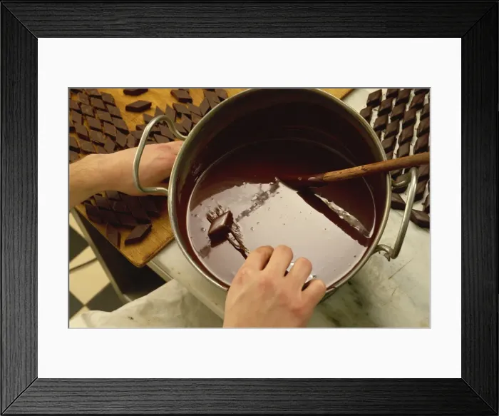 Framed Print : Making chocolates by hand