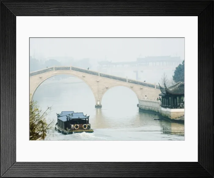 Framed Print : A boat passing through a stone arched bridge on Waicheng River with Wumen bridge behind Framed Print : A boat passing through a stone arched bridge on Waicheng River with Wumen bridge behind