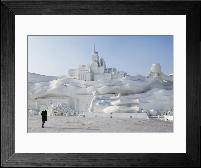 Framed Print : A lone person photographing a giant sculpture at Snow and Ice Sculpture Festival on Sun Island Park