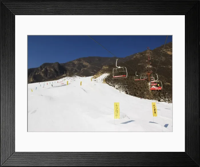 Framed Print : A ski lift taking skiers up to the slopes at Shijinglong ski resort, Beijing, China, Asia Framed Print : A ski lift taking skiers up to the slopes at Shijinglong ski resort, Beijing, China, Asia