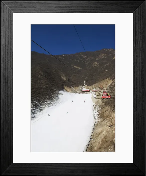 Framed Print : A ski lift taking skiers up to the slopes at Shijinglong ski resort, Beijing, China, Asia Framed Print : A ski lift taking skiers up to the slopes at Shijinglong ski resort, Beijing, China, Asia