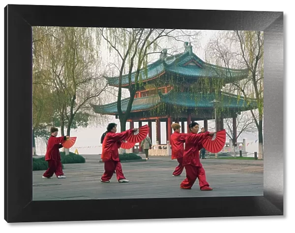Women practising tai chi in front of a pavilion on West Lake, Hangzhou