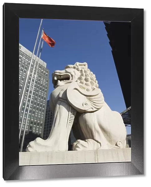 A stone lion statue in the Central Business District business district, Beijing, China, Asia